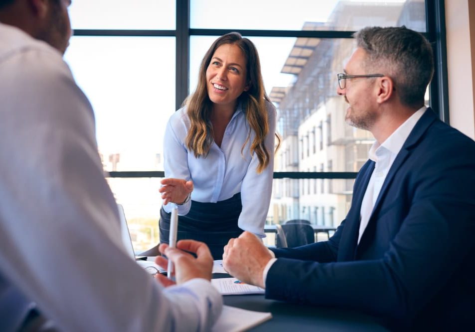 Business,Team,Meeting,Around,Office,Boardroom,Table,With,Laptops,Discussing
